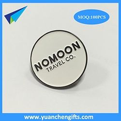 Black metal pin badge with white background